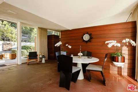 a dining room with furniture and window