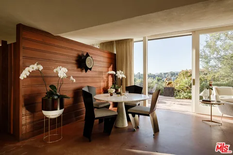 a dining room with furniture and wooden floor