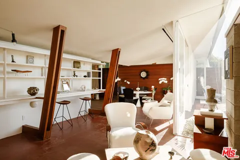 a dining room with furniture and wooden floor