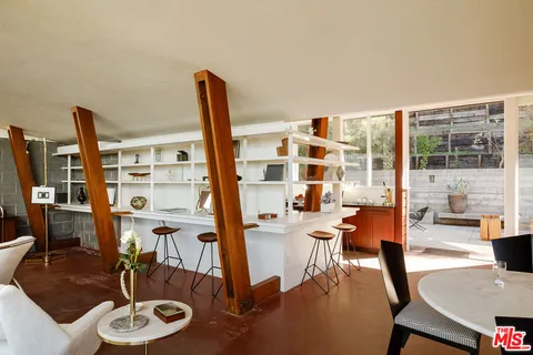 a living room with furniture and a floor to ceiling window
