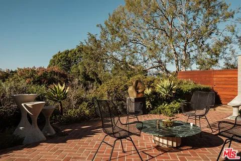 a view of a chairs and table in the patio