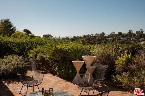 a view of a chairs and table in patio