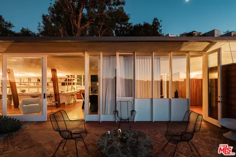 a view of balcony with chairs and iron fence