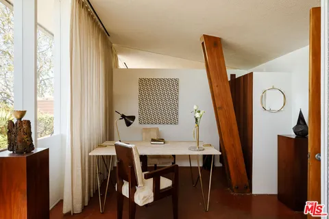 a bed sitting in a bedroom next to a window