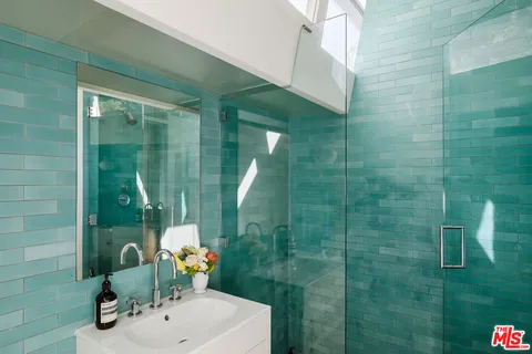 a view of a yard with plants and a fountain