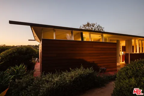 a front view of a building with glass windows and door
