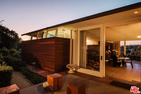 a bedroom with furniture and a potted plant