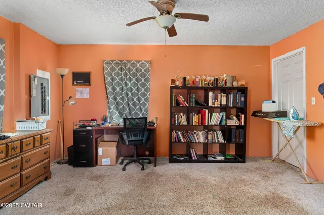 a view of room with window and ceiling fan