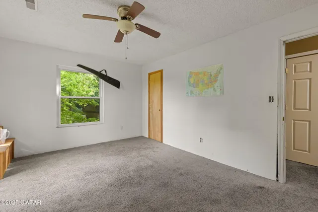 a view of room with workspace and windows