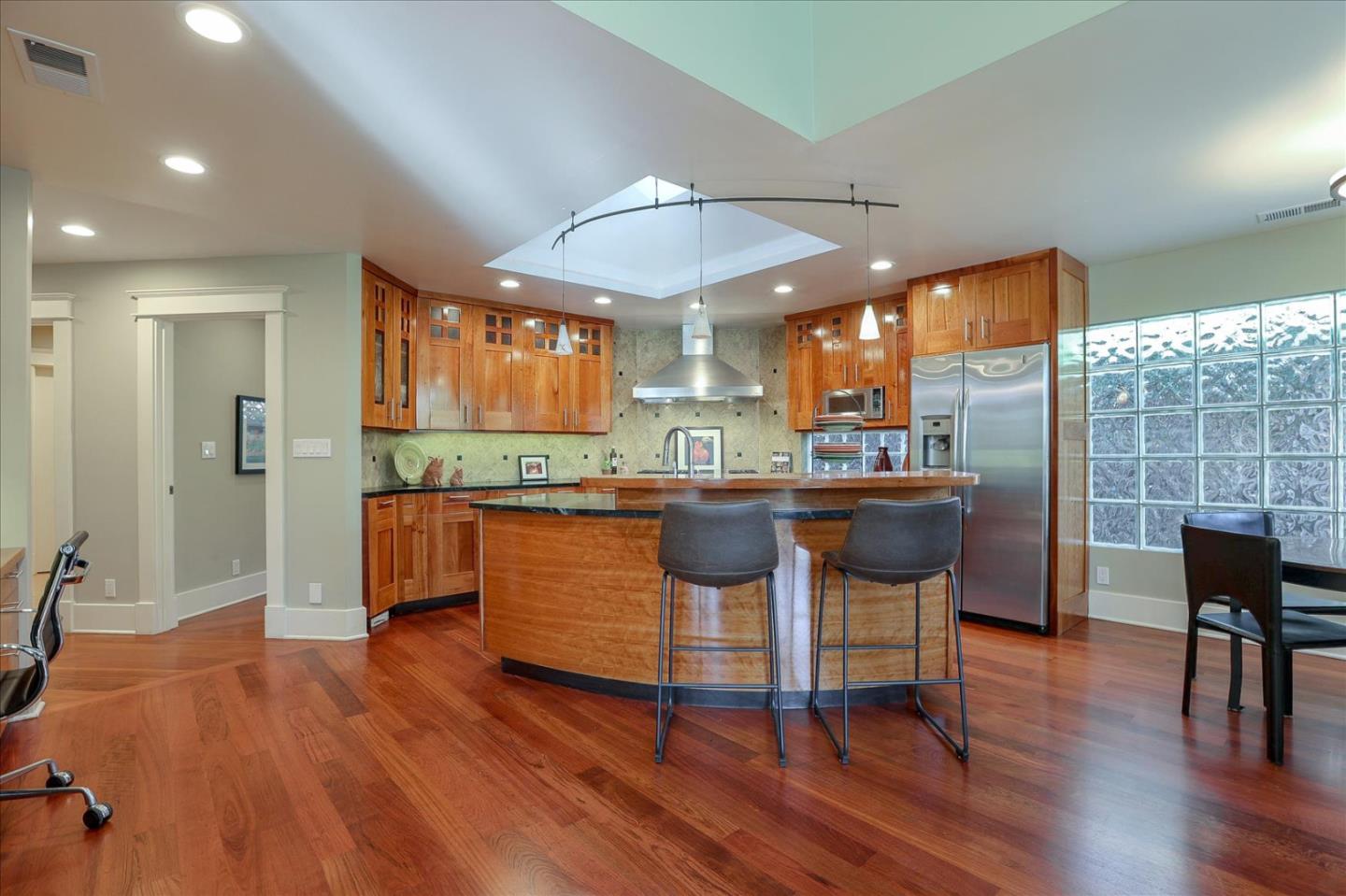 718 Covington Road Los Altos, CA 94024 - Photo 14 of 49 a kitchen with granite countertop wooden floors and white cabinets