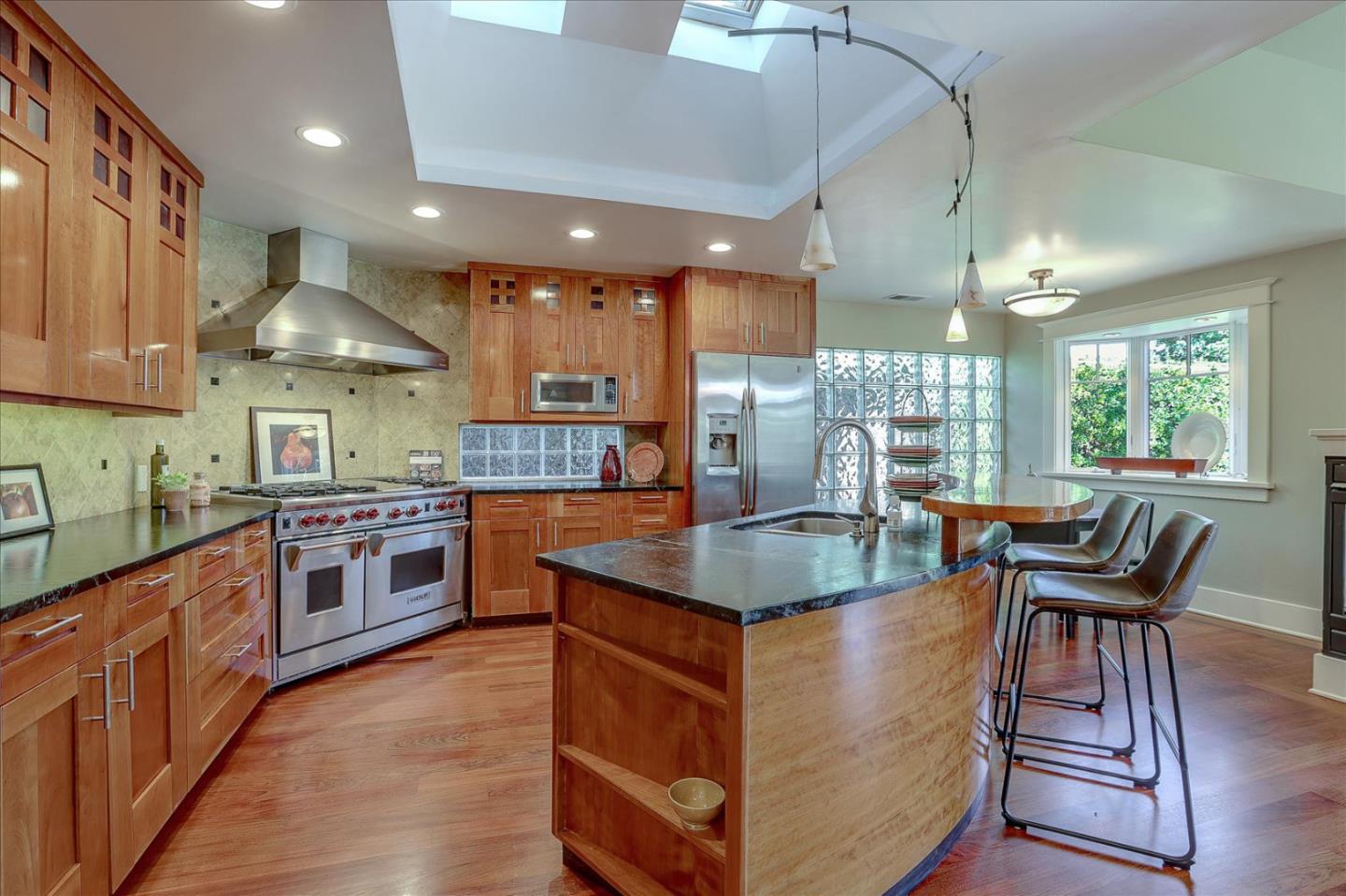 718 Covington Road Los Altos, CA 94024 - Photo 16 of 49 a kitchen with stainless steel appliances granite countertop a stove top oven a sink dishwasher a dining table and chairs