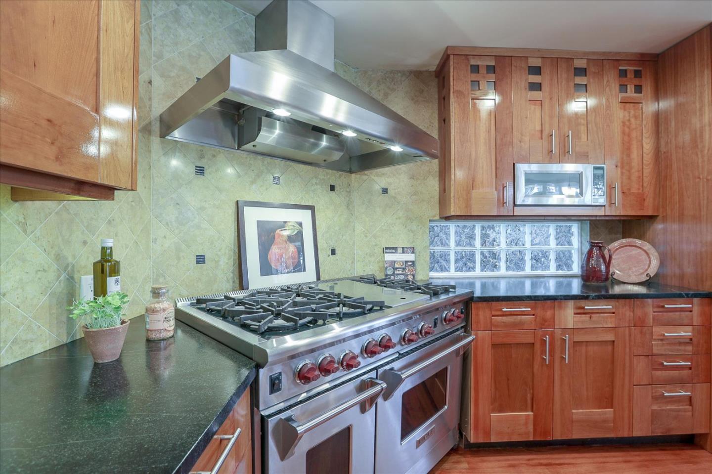718 Covington Road Los Altos, CA 94024 - Photo 17 of 49 a kitchen with stainless steel appliances granite countertop a stove and cabinets