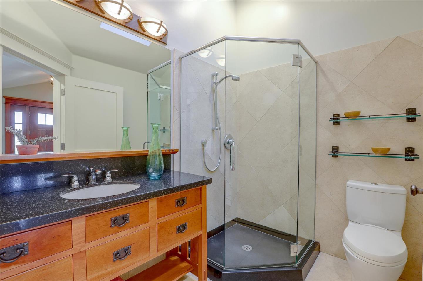 718 Covington Road Los Altos, CA 94024 - Photo 30 of 49 a bathroom with a granite countertop sink a toilet a mirror and shower