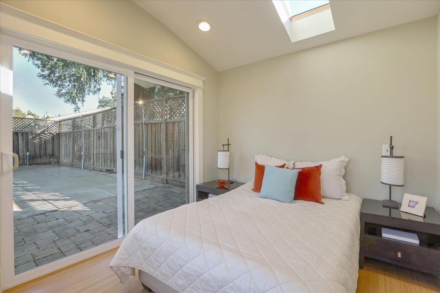 718 Covington Road Los Altos, CA 94024 - Photo 40 of 49 a bedroom with a large bed and a lamp