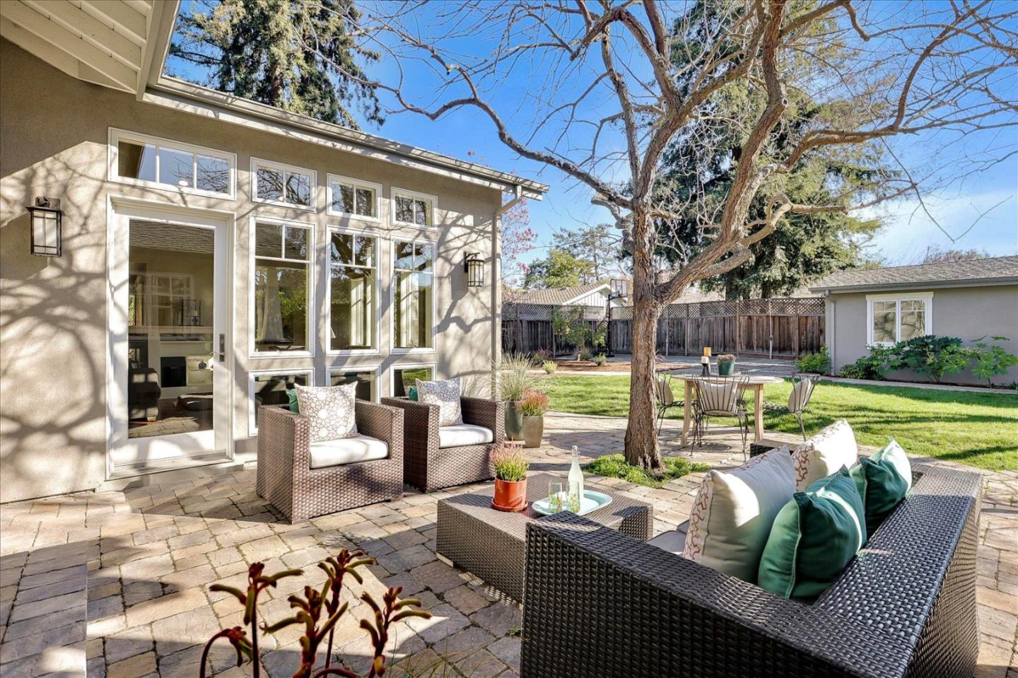 718 Covington Road Los Altos, CA 94024 - Photo 42 of 49 a view of a patio with couches chairs and a floor to ceiling window next to a yard