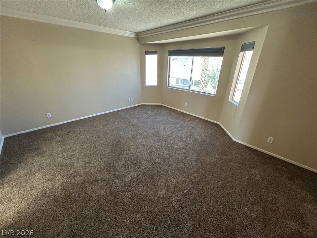 2806 Rungsted Street Las Vegas, NV 89142 - Photo 17 of 18 A spacious room features plush brown carpeting and multiple windows for abundant natural light.