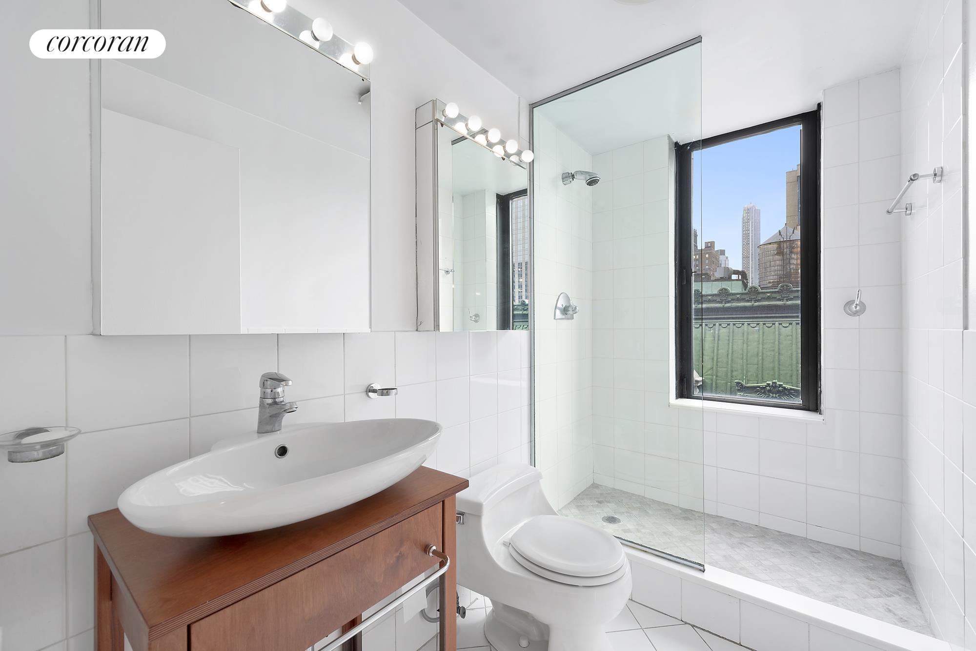445 5th Avenue, Unit 16F Manhattan, NY 10016 - Photo 5 of 8 a bathroom with a sink toilet and shower