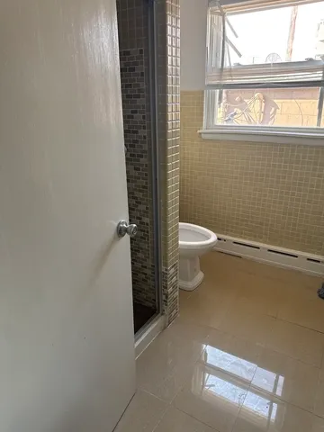 a kitchen with stainless steel appliances a stove top oven a sink a counter space and wooden floor