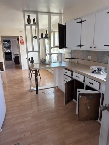a view of livingroom with floor to refrigerator