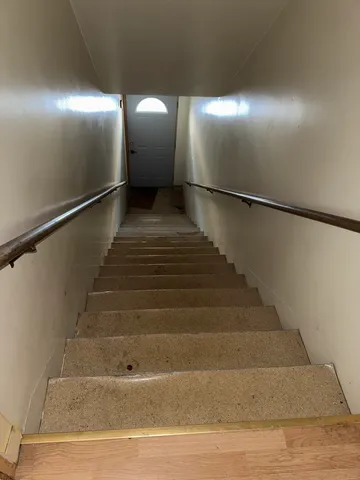 a living room with couches and large window with wooden floor