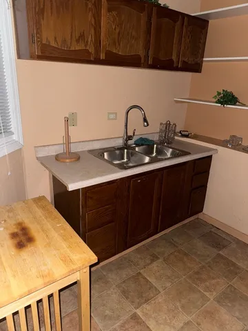 a kitchen with a sink and cabinets
