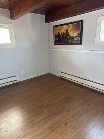 a view of room with window and hardwood floor