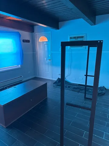 a room with wooden floor and a chair