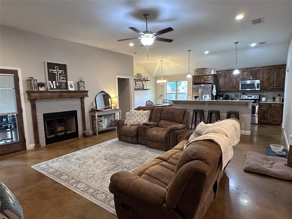 1212 Bowman Ridge Road Stephenville, TX 76401 - Photo 7 of 23 a living room with furniture and a fireplace