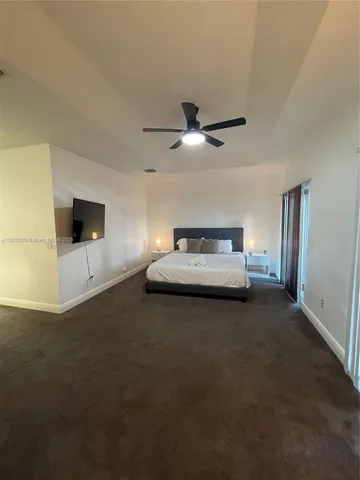 a spacious bathroom with a granite countertop sink a mirror and a bathtub