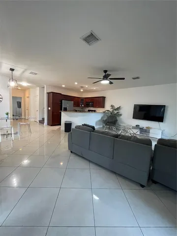a kitchen with stainless steel appliances kitchen island granite countertop a sink and cabinets