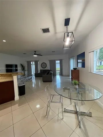 a living room with furniture a dining table and chairs