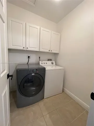 a bedroom with two beds and a ceiling fan