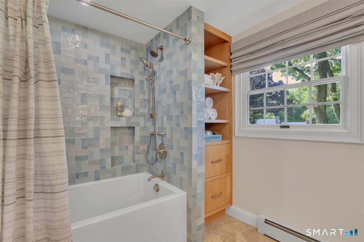 361 Miles Road Orange, CT 06477 - Photo 16 of 40 Completely remodeled in 2025, this full bath features stylish tile flooring, a combination tub/shower, and convenient built-in storage.