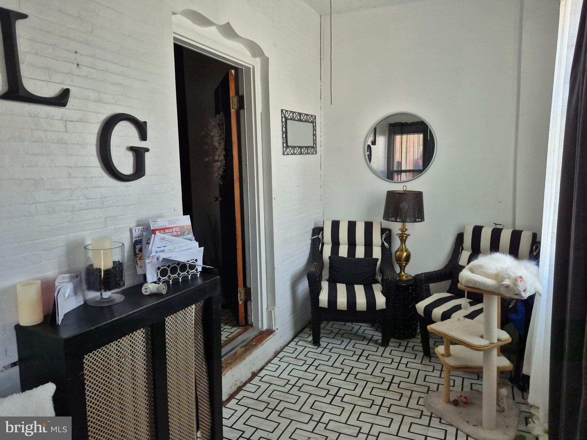 6016 West Thompson Street Philadelphia, PA 19151 - Photo 2 of 9 a living room with furniture and a window