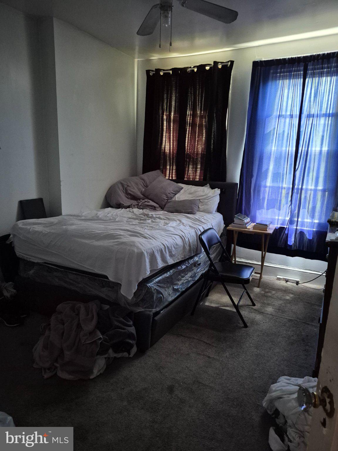 6016 West Thompson Street Philadelphia, PA 19151 - Photo 7 of 9 a bed sitting in a room next to a window