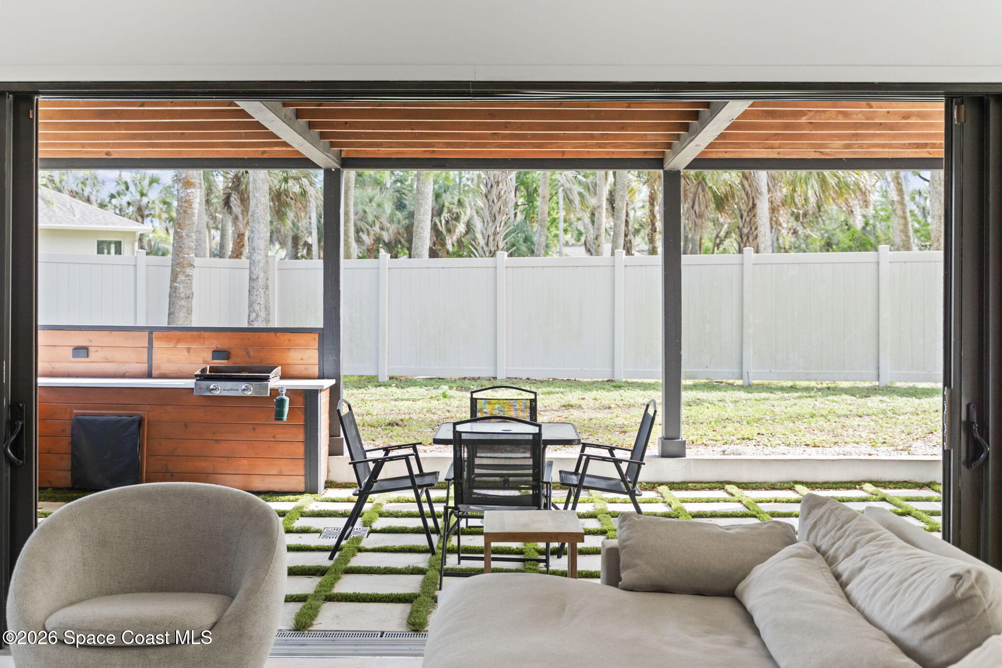 785 Seymour Road Northeast Palm Bay, FL 32905 - Photo 26 of 67 a living room with furniture and floor to ceiling windows