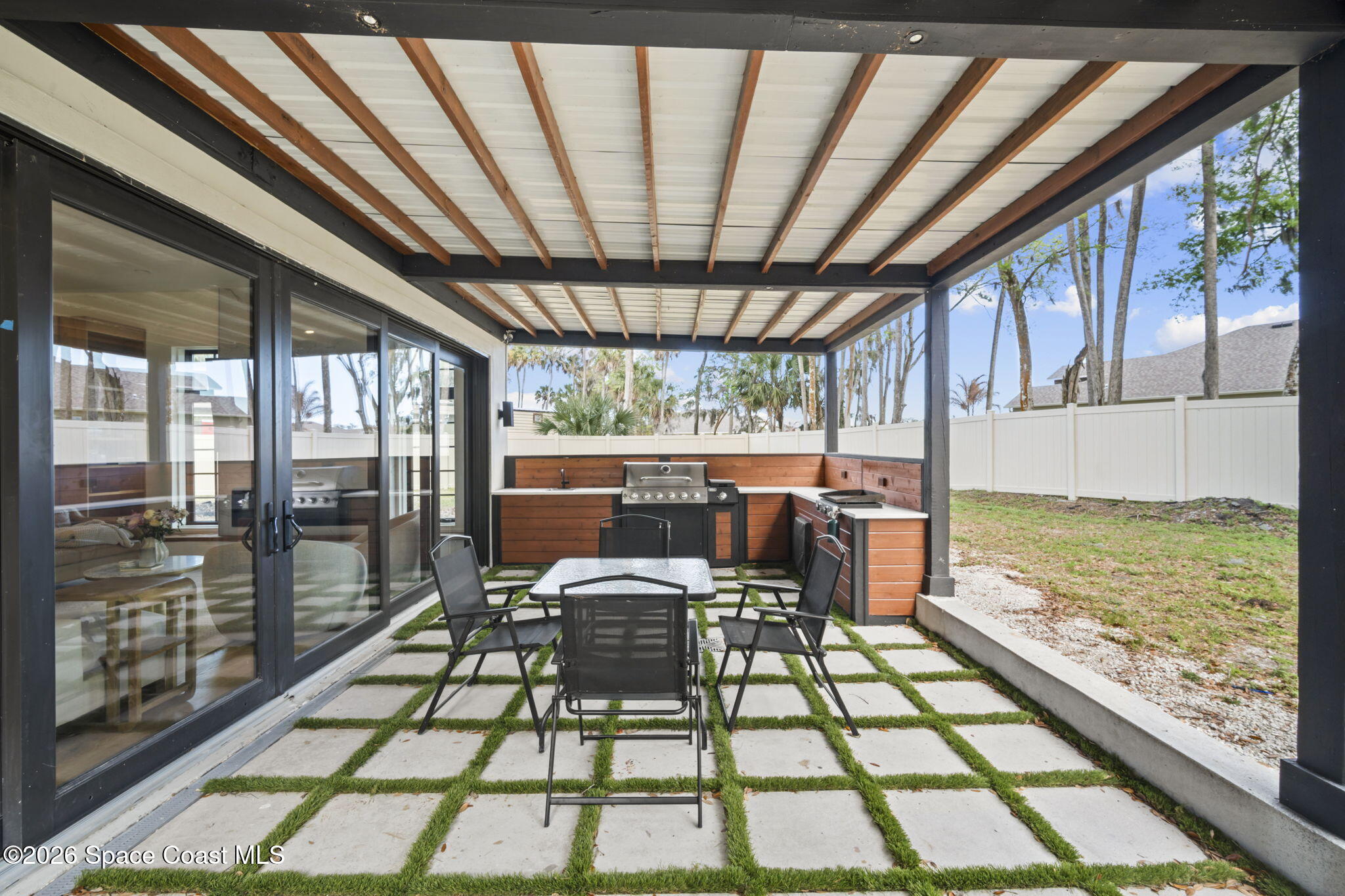 785 Seymour Road Northeast Palm Bay, FL 32905 - Photo 29 of 67 a view of a porch with furniture and floor to ceiling window