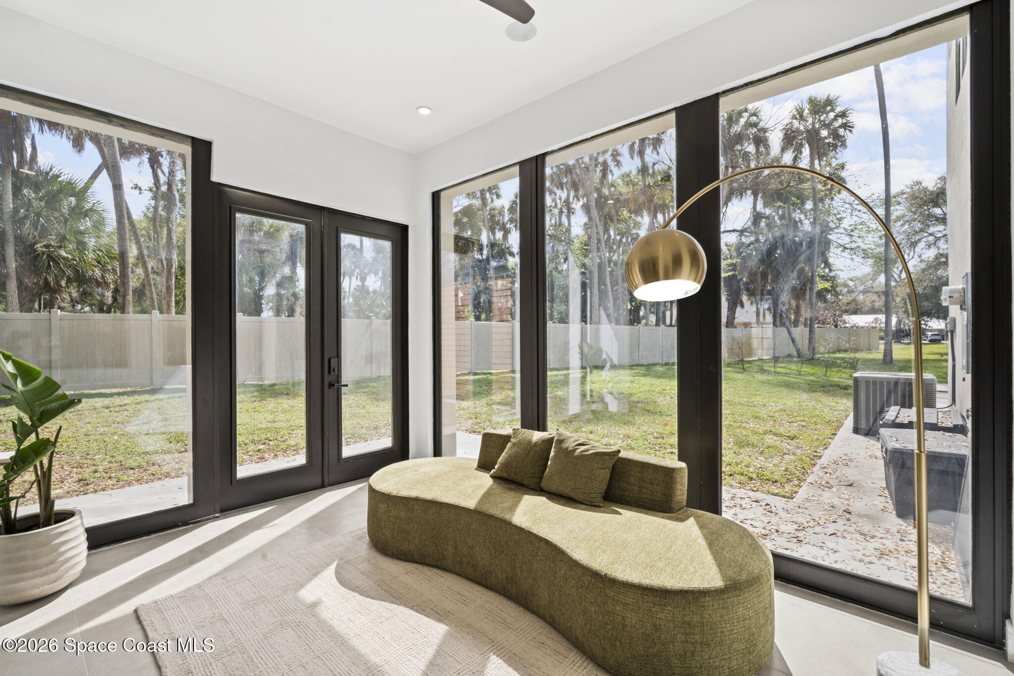 785 Seymour Road Northeast Palm Bay, FL 32905 - Photo 30 of 67 a bedroom with furniture and large windows