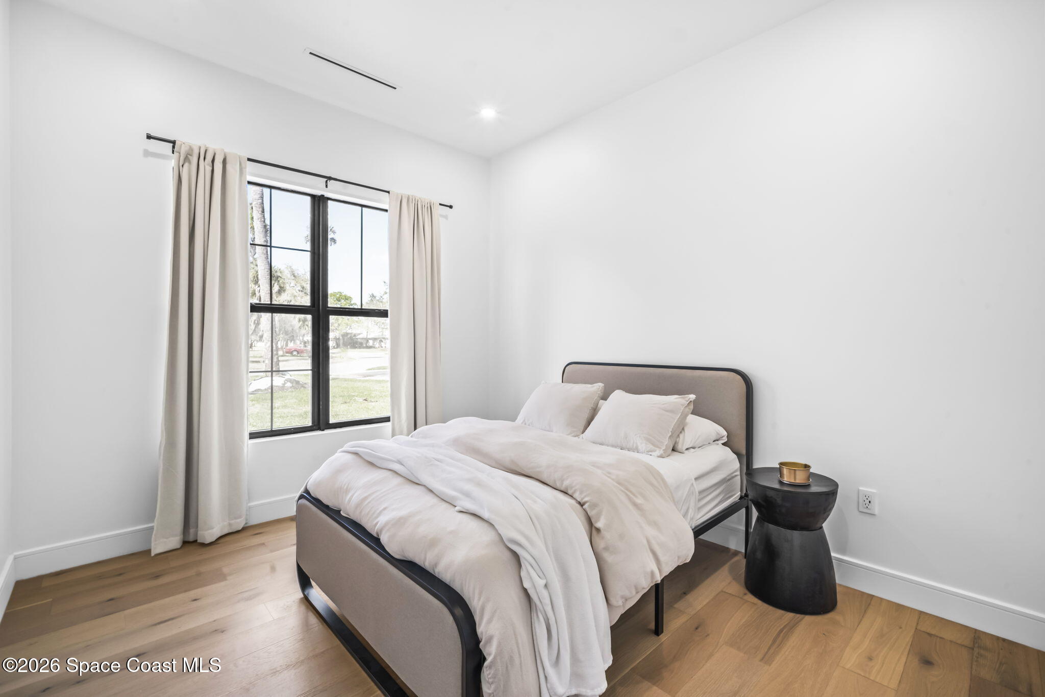 785 Seymour Road Northeast Palm Bay, FL 32905 - Photo 38 of 67 a bedroom with a bed and wooden floor