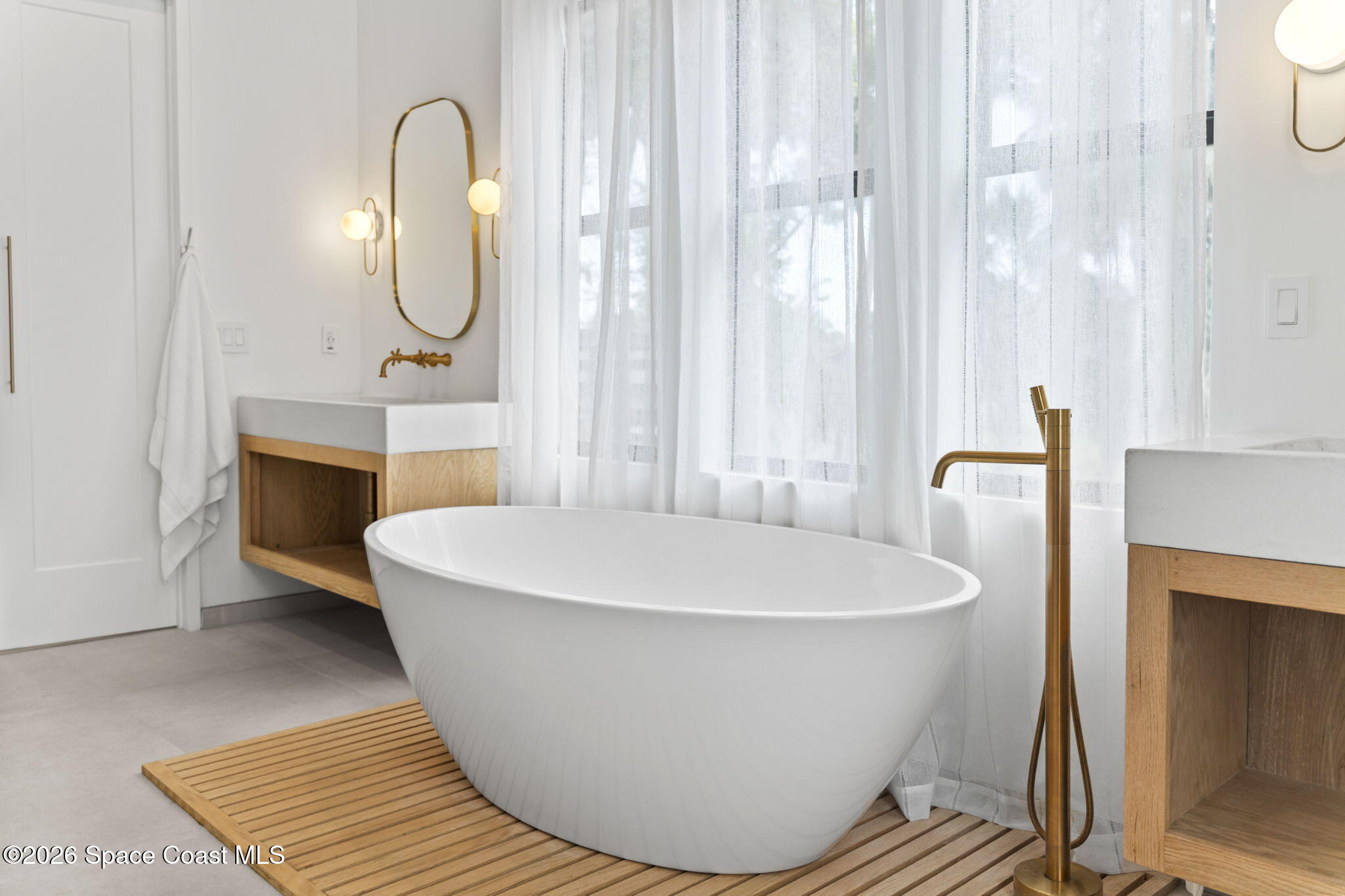785 Seymour Road Northeast Palm Bay, FL 32905 - Photo 50 of 67 a white bath tub sitting in a bathroom