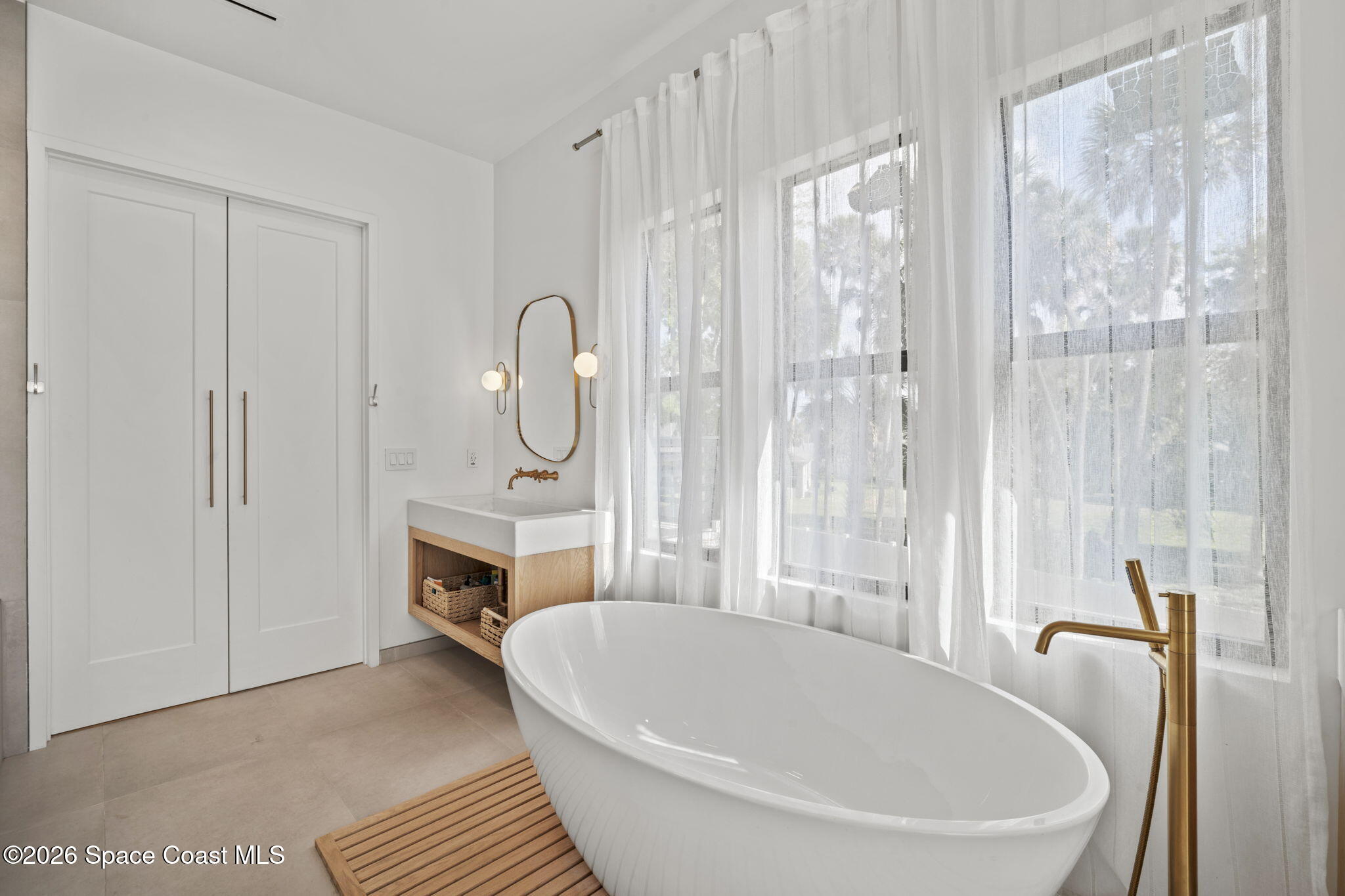 785 Seymour Road Northeast Palm Bay, FL 32905 - Photo 56 of 67 a white bath tub sitting next to a white tub