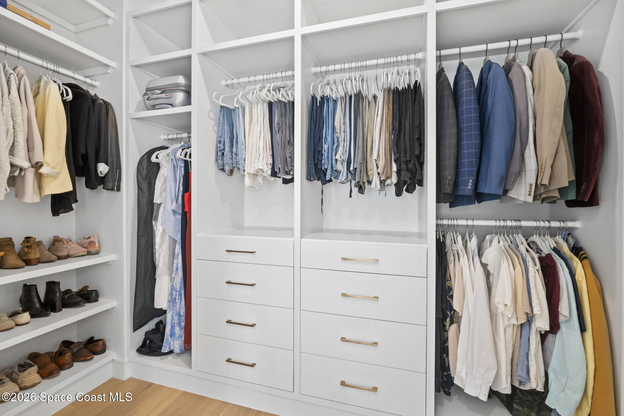 785 Seymour Road Northeast Palm Bay, FL 32905 - Photo 57 of 67 a view of walk in closet with clothes and shoes