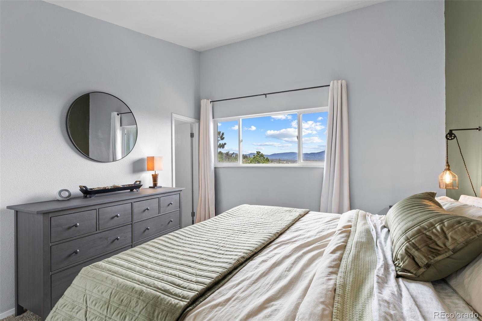 518 Pine Drive Bailey, CO 80421 - Photo 21 of 43 a bedroom with a bed and a dresser
