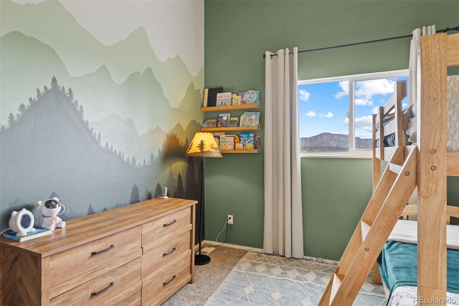 518 Pine Drive Bailey, CO 80421 - Photo 26 of 43 a room with a baby crib and a dresser