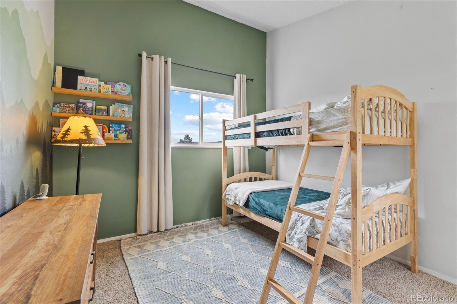 518 Pine Drive Bailey, CO 80421 - Photo 27 of 43 a bedroom with bunk bed and a table