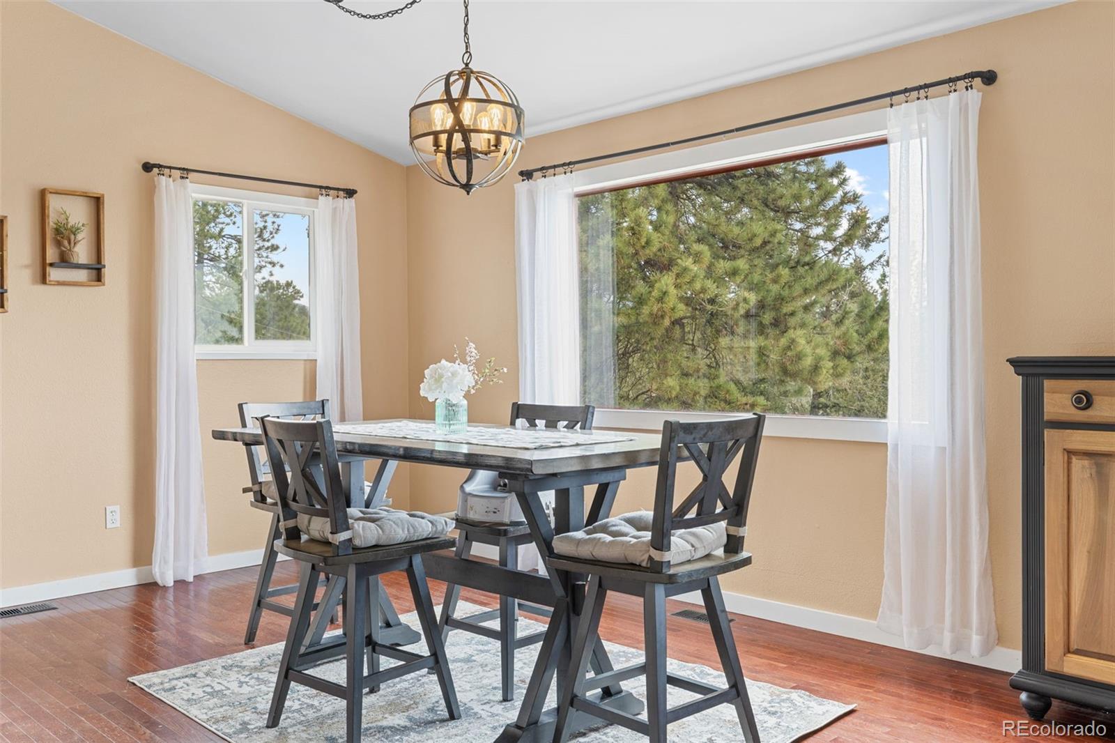 518 Pine Drive Bailey, CO 80421 - Photo 6 of 43 a view of a dining room with furniture window and wooden floor