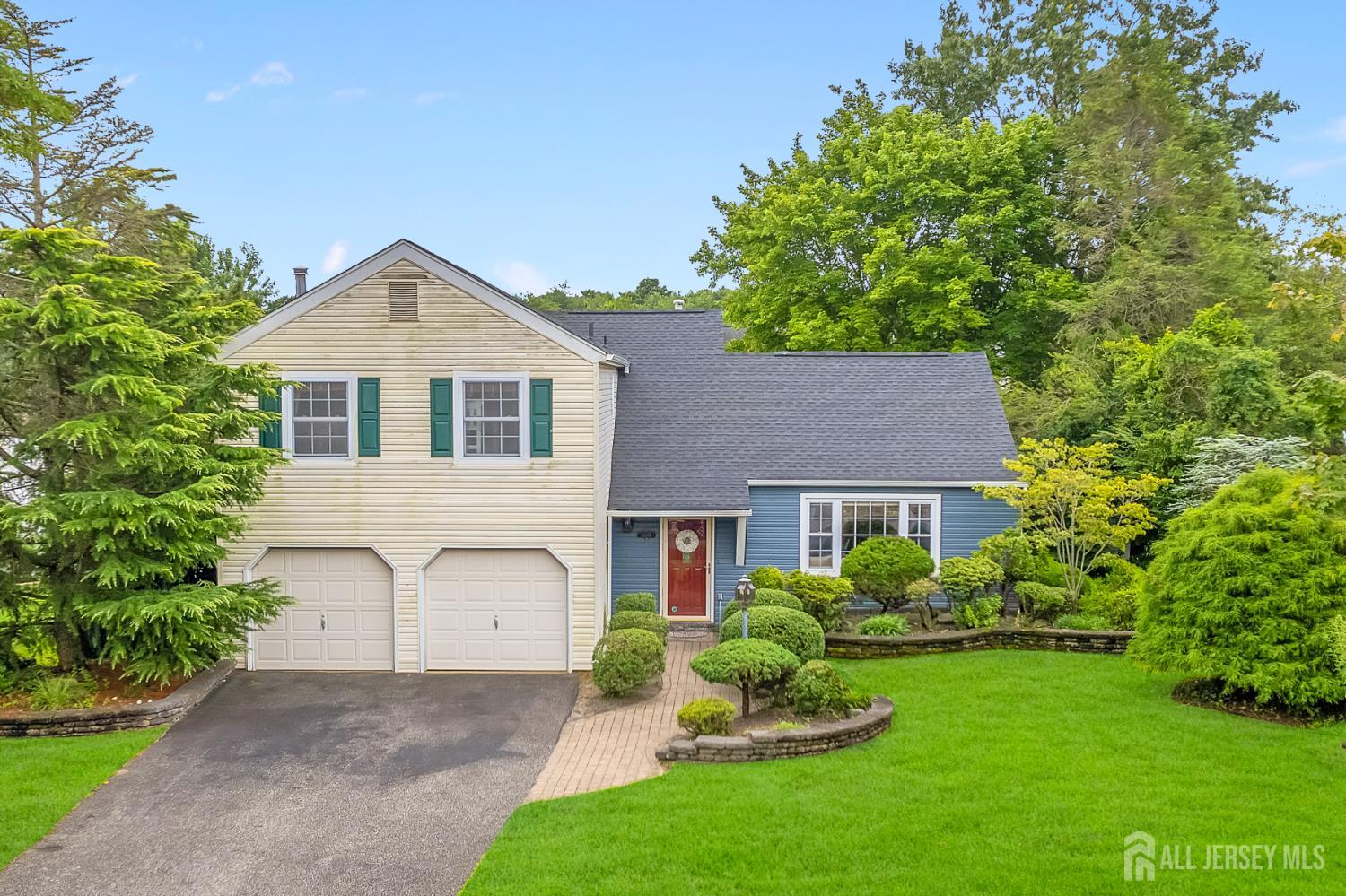a front view of a house with a garden and plants