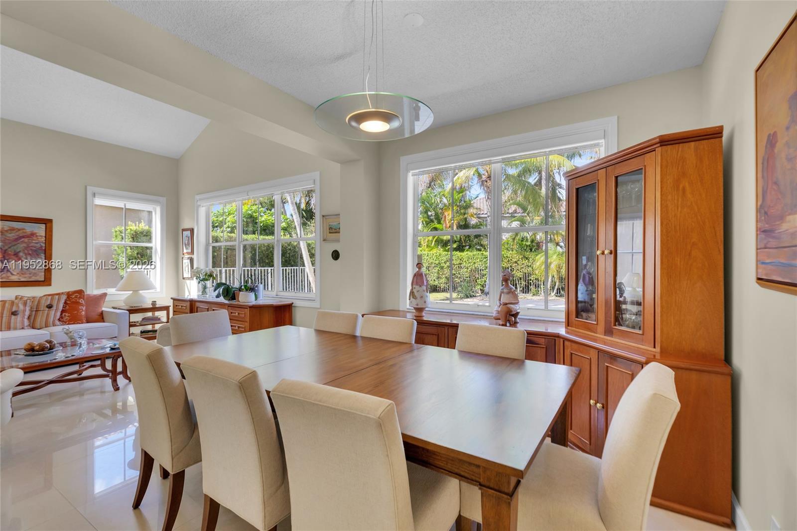 4441 Stone Ridge Way Weston, FL 33331 - Photo 11 of 87 a view of a dining room with furniture large windows and wooden floor
