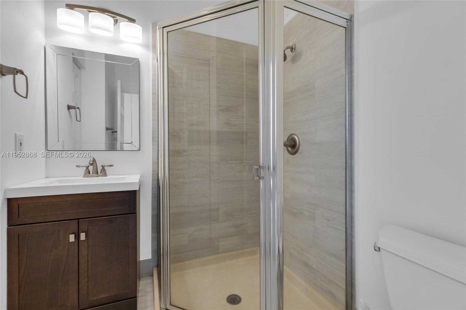 4441 Stone Ridge Way Weston, FL 33331 - Photo 18 of 87 a bathroom with a shower sink and mirror