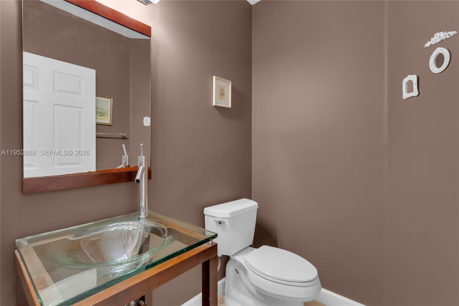 4441 Stone Ridge Way Weston, FL 33331 - Photo 19 of 87 a bathroom with a sink and a toilet